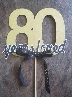 a cake topper with the number 80 on it