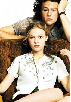 a movie poster for the film no things i hate about you, featuring a man and woman sitting on a couch