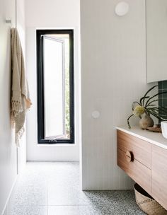 a bathroom with a sink, mirror and window