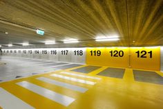 an empty parking garage with yellow and white stripes