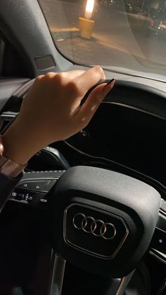 a hand on the steering wheel of a car