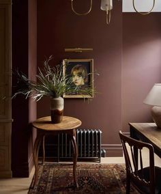 a table with a potted plant sitting on top of it next to a radiator