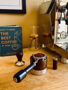 a coffee grinder sitting on top of a wooden table