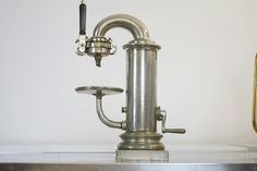 a silver faucet sitting on top of a metal counter