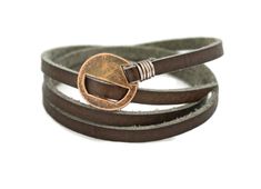 two brown leather bracelets with an open circle on the clasp and a metal hook