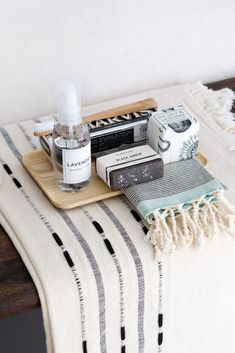 towels, soaps and other items on a tray with text overlay that reads tip 46 stock up on toiletries + towels