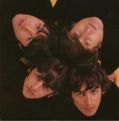 four people are laying down in the middle of a group photo with their heads on each other's shoulders