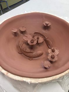 a clay bowl that has flowers on it