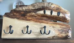 a wooden board with hooks on it sitting on a table