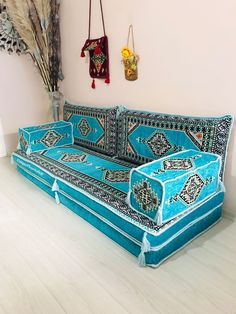 a blue couch sitting on top of a hard wood floor