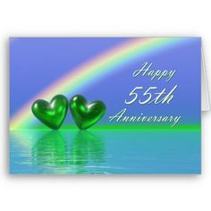 an anniversary card with two green hearts on the water and a rainbow in the background