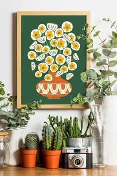 an art print of a potted plant on a shelf