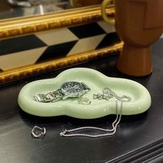 a green object sitting on top of a table next to a mirror