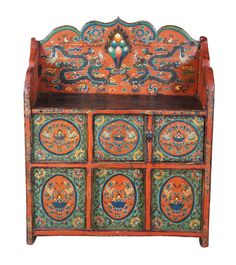 an orange and blue painted cabinet with four drawers