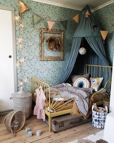 a bedroom with a canopy bed and lots of decorations on the wall above it,