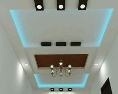 an empty room with white walls and ceiling lights