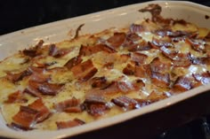 a casserole dish with ham and cheese in it sitting on the stove top