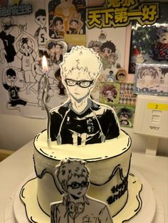 a birthday cake with an anime character on it and a candle in the shape of a man