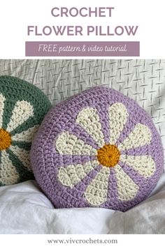 two crochet flower pillows sitting next to each other on a white bed with text overlay