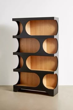 a wooden shelf with several compartments on each side and one section open to show the inside