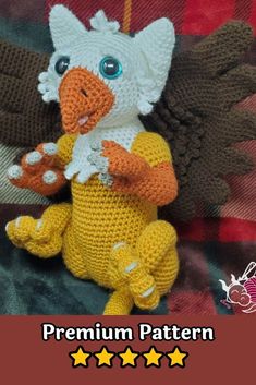 a crocheted stuffed bird sitting on top of a blanket