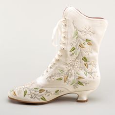 Indulge in a piece of history with Flora Embroidered Boots, an exclusive reproduction of the intricate opera and evening boots popular in the late Victorian period. Expertly crafted with intricate botanical detailing, these stunning satin boots will take you back to an era of sophistication and finesse. Wear them with bustle and Belle Epoque attire from the 1870s to c. 1900, or with modern dress as a statement piece. The Flora Boots are designed in collaboration with the Bata Shoe Museum. Every Satin Boots, Edwardian Shoes, Bata Shoes, American Duchess, Victorian Shoes, Victorian Boots, Bridal Boots, 2024 Aesthetic, Boots Wide