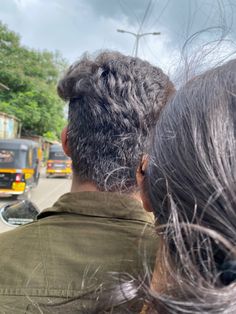 a man and woman are looking at the traffic