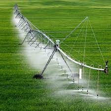 a sprinkler spraying water on a green field