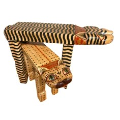 a wooden bench made to look like a cat with stripes on it's body