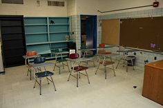 an empty classroom with desks and chairs