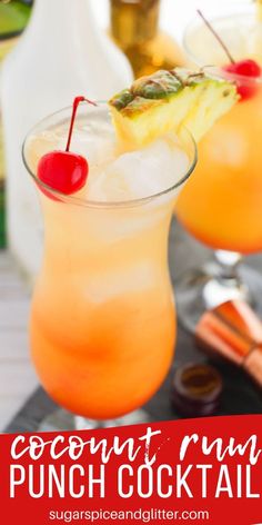 two glasses filled with orange punch cocktails on top of a black tray next to other drinks