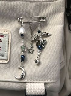 a white purse with some charms attached to it