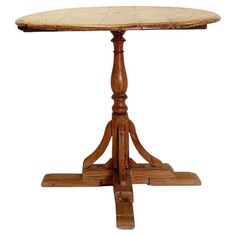 an old wooden table with two legs and a round top, on a white background