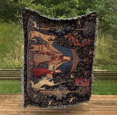 an old tapestry hanging on the side of a wooden floor with trees in the background