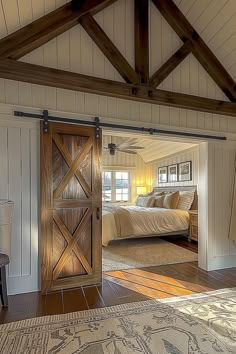 an open door leading to a bedroom with a large bed in the background and a rug on the floor