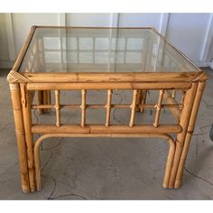 a glass top table with bamboo frame and legs