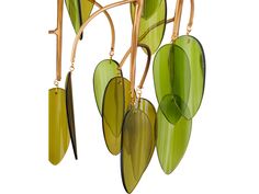 green leaves hanging from a tree branch with gold colored stems and long, thin hooks