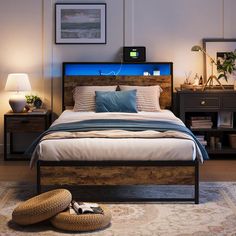 a bedroom with a bed, nightstands and pictures on the wall above it is lit up by blue light