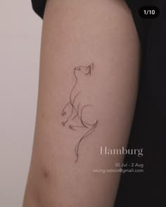 a woman's arm with a cat tattoo on the left side of her body