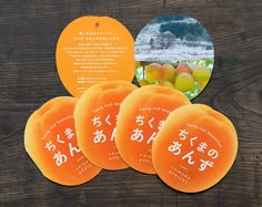 four orange frisbees with chinese writing on them sitting on a wooden table