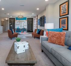 a living room with couches, chairs and pictures on the wall in it's center