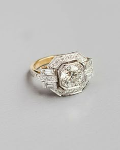 an antique diamond and gold ring with baguets on the sides, set in 18k yellow gold