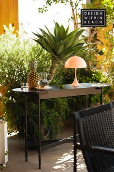 black outdoor table in greenery setting