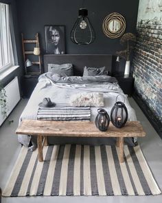 a bed room with a neatly made bed next to a window and a rug on the floor