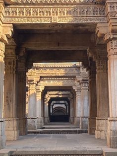 an archway in the middle of a building with carved pillars and columns on either side