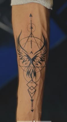 a tattoo on the leg of a person with an arrow and bird in it's wings