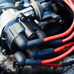 an engine with red and black hoses connected to it's housing system,