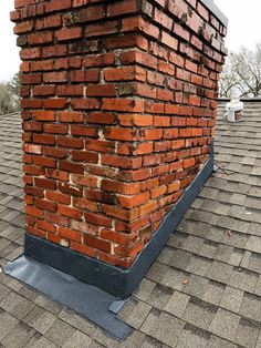 a brick chimney on top of a roof