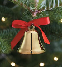 a bell ornament hanging from a christmas tree