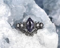 a fancy ring sitting on top of some ice